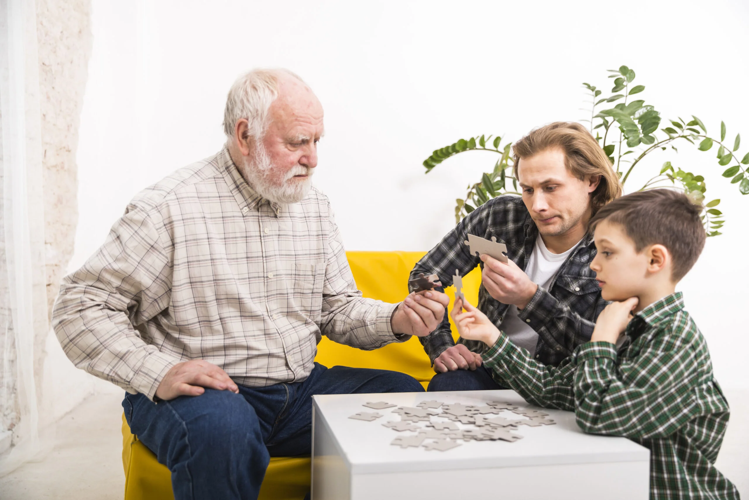 Focused multi generational family assembling jigsaw puzzle together scaled